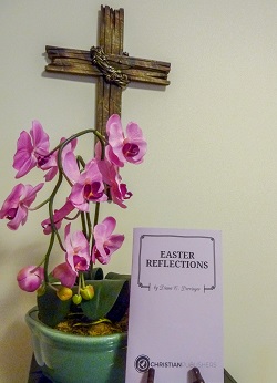 Easter Reflections play script, flower, and cross in background