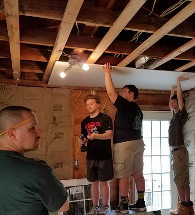 A Good Day's Work for a Good Day's Pay--youth replacing a ceiling