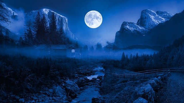 Once in a Blue Moon: Full moon shining in a blue landscape